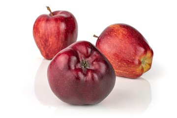 Group of three whole fresh apple red delicious one in the front isolated on white background