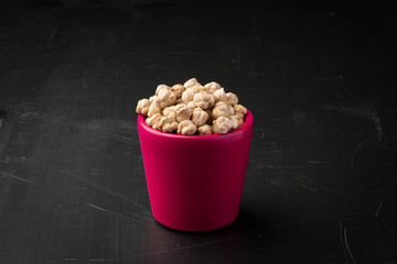 Chickpeas in the pink glass on the table