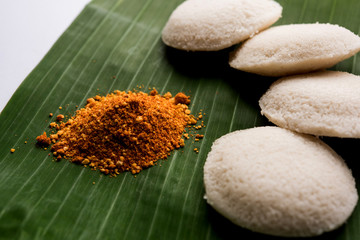 Podi idli is a quick and easy snack made with leftover idly. served with sambar and coconut chutney. selective focus