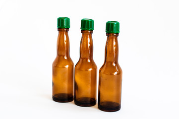 Perspective close-up shoot of three small alcohol bottles brown colored