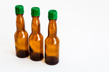 Perspective up shoot of three small alcohol bottles brown colored
