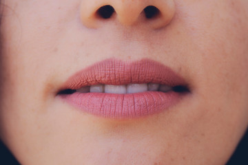 Fototapeta premium Perfect natural lip makeup. Close up macro photo with beautiful female mouth. Plump full lips. Close-up face detail. Perfect clean skin, light fresh lip make-up. Beautiful spa tender lip