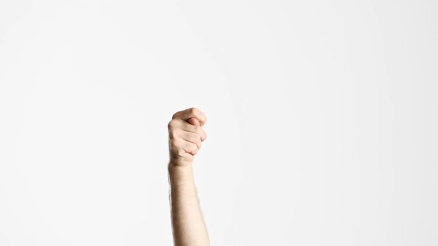 Cropped view of man showing fig gesture with hand raised from below over white background isolated