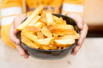 Girl holding bowl of potato chips fries 