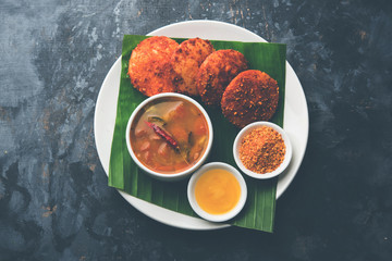 Podi idli is a quick and easy snack made with leftover idly. served with sambar and coconut chutney. selective focus
