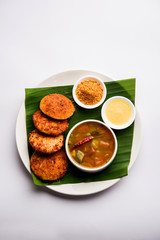 Podi idli is a quick and easy snack made with leftover idly. served with sambar and coconut chutney. selective focus