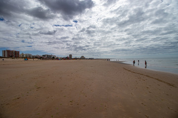 on the beach with clouds