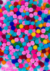 A colorful of Pom Pom background, top view colorful pom poms background.