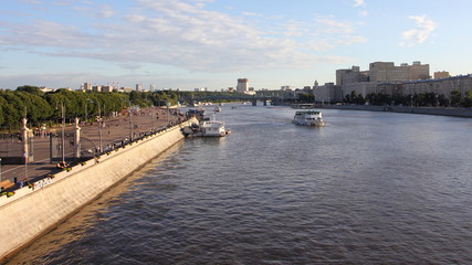 Fototapeta na wymiar Top view of Pushkin embankment, St. Andrew's bridge in Gorky Park and the Moscow river with ships on a Sunny summer day against the blue sky