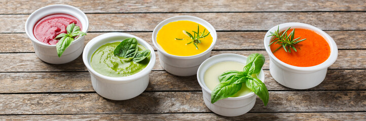 Set of seasonal fall autumn creamy soups on a table