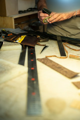 Tailor process leather in workshop.