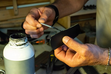 Tailor process leather in workshop.