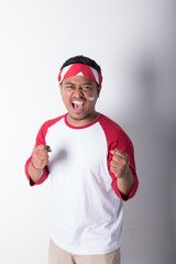 Naklejka premium portrait of young asian male holding indonesian flag. patriotic nationalism concept
