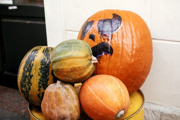 Halloween street decor. Jack o lantern pumpkins on city street, holiday decor of store fronts and buildings. Autumn market in town. Space for text. Trick or treat. Happy halloween
