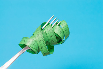on a blue background, on a fork wound meter slimming concept