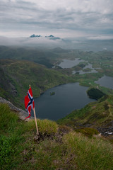 Norwegian flag in the mountains. lake mountains fog.