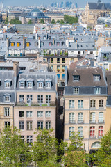 Fototapeta na wymiar Paris, typical roofs in the Marais, aerial view with the Halles, the Saint-Eustache church and the Defense in background 