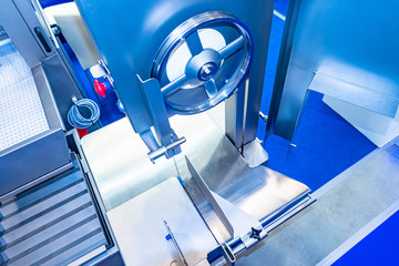 Band saw in the food industry. Equipment for cutting meat and fish. Butchering meat carcasses in production. Equipment for cutting meat for industrial purposes. Fish processing.