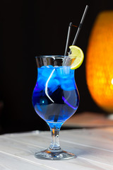 Alcoholic cocktail stands on the table in a cafe. Close-up