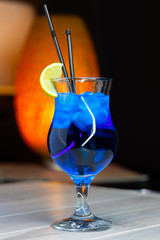 Alcoholic cocktail stands on the table in a cafe. Close-up