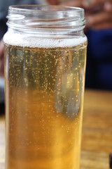 bottle of beer with water drops on black background