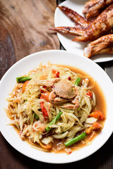 Spicy papaya salad and grilled chicken wing. Thai food (Som Tum)