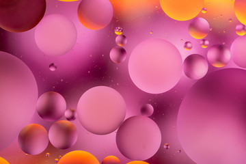  oily drops in water with colorful background, close-up 