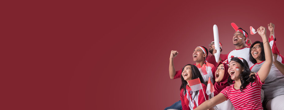 group portrait of young indonesian supporter people watching soccer match with excitement