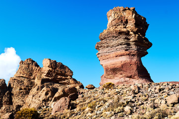 Fototapeta premium big high old stone in the desert with blue sky on the background