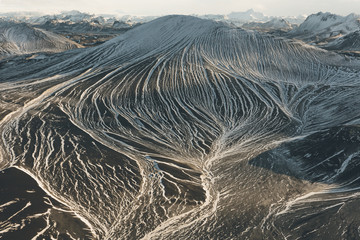 Snow trapped in between lower breaks in the mountain create a memorizing visual effect.