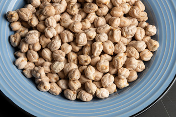 Chickpeas in the blue plate on the table