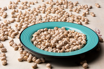 Chickpeas in the blue plate on the table