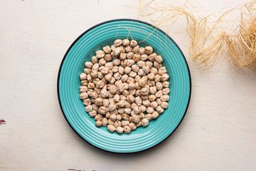 Chickpeas in the blue plate on the table