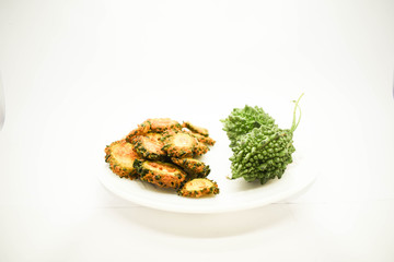 Bitter Gourd Fry with Rice flour served on a white plate and background