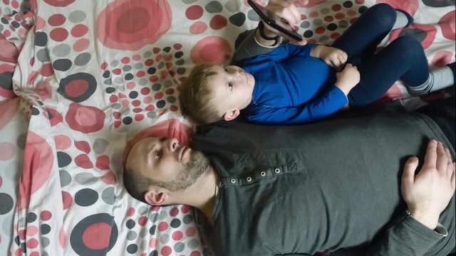 Father and baby child using smartphone