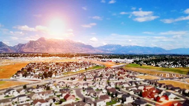 Idyllic community in a valley with the Rocky Mountains in the background - tilt shift effect