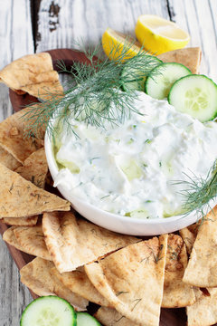Traditional Greek Tzatziki dip sauce made with cucumber sour cream, Greek yogurt, lemon juice, olive oil and a fresh sprig of dill weed. Served with toasted Za'atar Pita bread.