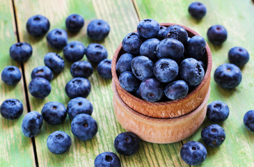 Fresh blueberry in a wooden bowl