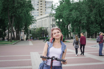 Girl on a scooter in a city park