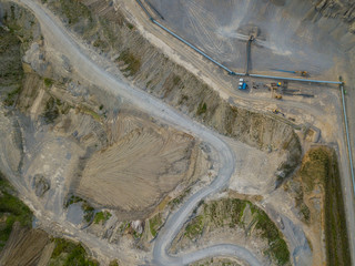 Aerial view of conveyor belt in open gravel quarry for raw material transportation