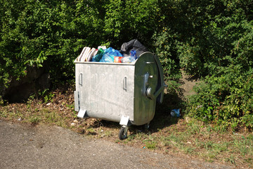 Overfilled waste container with garbage