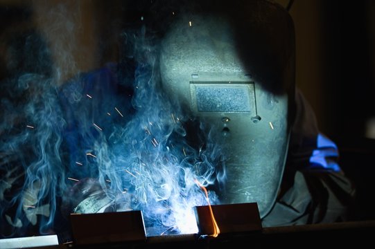 Welder with protective mask in steel construction, detail, Germany, Europe