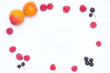 Summer background concept. Frame from raspberries, currants, apricots on white background.