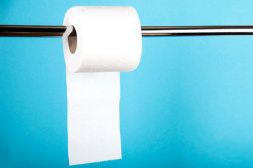 A roll of white toilet paper on a colored background