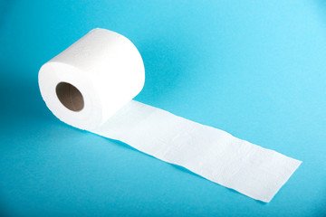 A roll of white toilet paper on a colored background