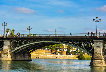 Fototapeta na wymiar The Triana Bridge of Seville and the Guadalquivir river, Andalusia, Spain.