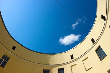 Fototapeta premium Round yard of scenic circle yellow old house in Saint Petersburg, Russia with the bright blue summer sky