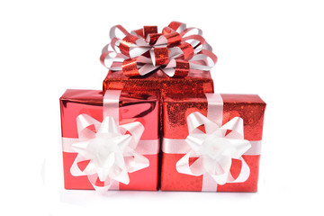 Red gift box and ribbon bow on white background. Concept for Valentine day, Christmas present and New Year.