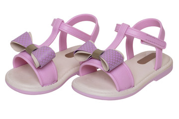 Pink sandals isolated. Close-up of cute pink sandals with a bow for the little girl isolated on a...