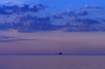 Commodities ship in the Gulf of a sea in sunset.
